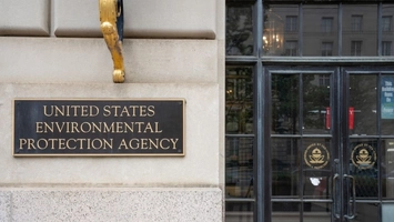 United States Environmental Protection Agency bronze sign on a stone building beside glass entrance doors